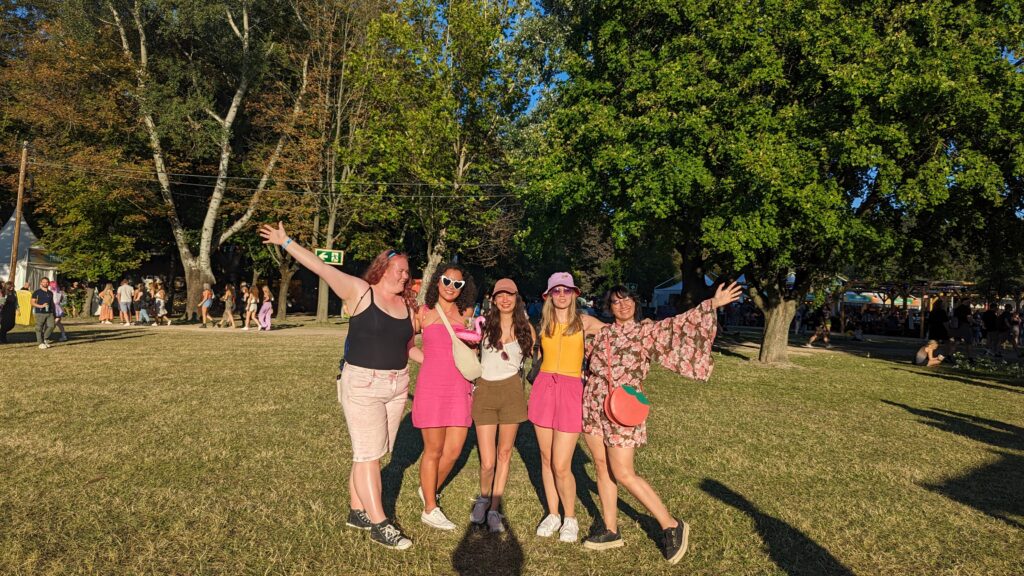 Festival Family group in daylight at Sziget with ferris wheel